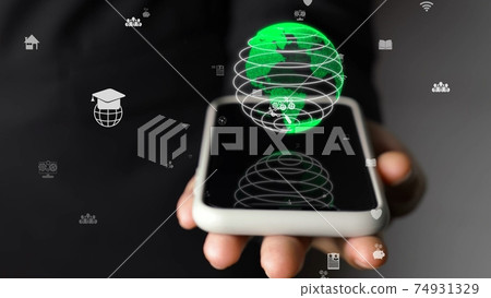 Human hand holding mobile phone with earth globe holographic technology Human hand holding mobile phone with earth globe holographic technology 74931329