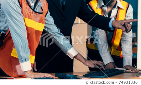 Warehouse manager and worker working in the storehouse Warehouse manager and worker working in the storehouse 74931336