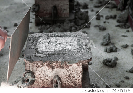 Concrete mix in iron mold and using concrete vibrator Concrete mix in iron mold and using concrete vibrator 74935159