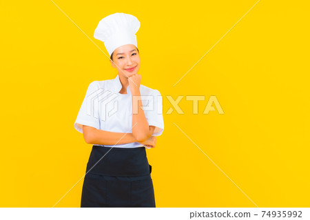 Portrait beautiful young asian woman in chef or cook uniform with hat Portrait beautiful young asian woman in chef or cook uniform with hat 74935992