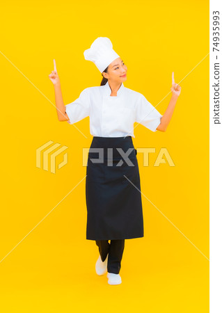 Portrait beautiful young asian woman in chef or cook uniform with hat Portrait beautiful young asian woman in chef or cook uniform with hat 74935993