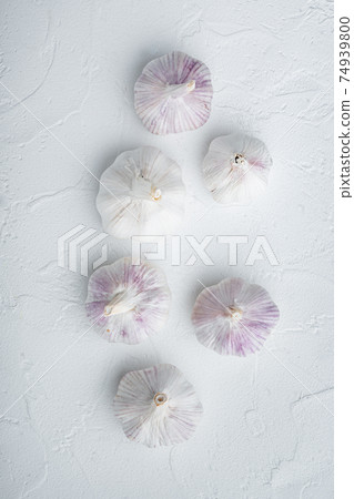Garlic. Fresh garlics, on white background, top view flat lay Garlic. Fresh garlics, on white background, top view flat lay 74939800