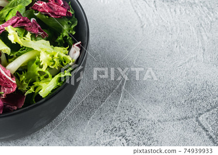 Bowls with mixed shredded salad lettuce leaves, on gray background with copy space for text 74939933
