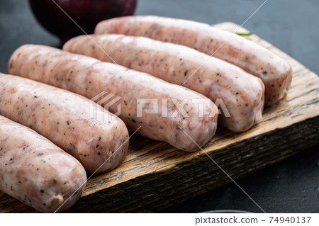 Traditional raw sausages, on black background Traditional raw sausages, on black background 74940137