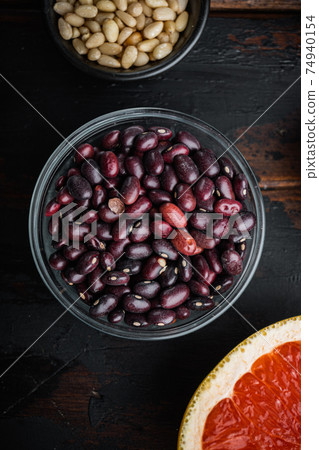 Red beans in bowl with healthy food, flat lay on dark wooden background Red beans in bowl with healthy food, flat lay on dark wooden background 74940154