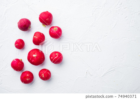 Bunch of ripe radishes, on white background, top view flat lay , with copyspace and space for text Bunch of ripe radishes, on white background, top view flat lay , with copyspace and space for text 74940371