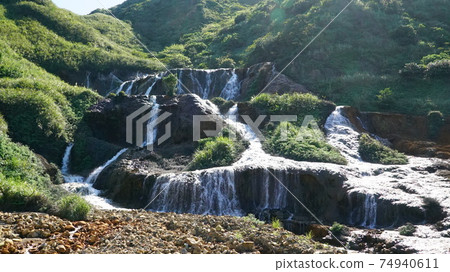 Flowing water on the rocks Flowing water on the rocks 74940611