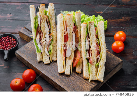 Deli meat sandwich with chicken, on dark wooden background 74940939