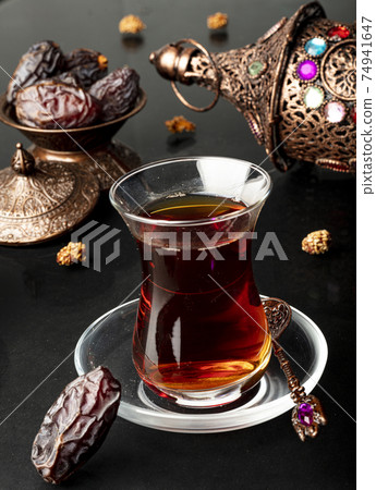 Ramadan concept with cup of tea and dried dates 74941647