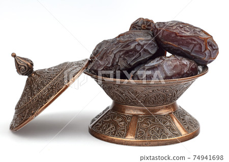Dates on a bronze plate isolated Dates on a bronze plate isolated 74941698