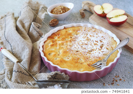 Apple clafoutis pie with praline in ceramic dish for sweet dessert and fresh apples 74941841
