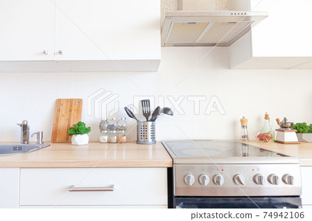 Scandinavian classic minimalistic kitchen with white and wooden details. Modern white kitchen clean contemporary style interior design. Scandinavian classic minimalistic kitchen with white and wooden details. Modern white kitchen clean contemporary style interior design. 74942106