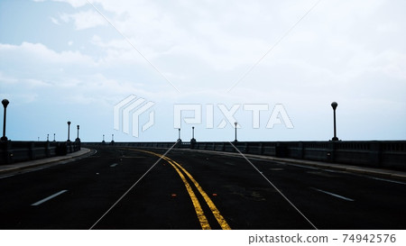 long bridge in misty fog 74942576