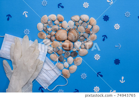 shells form of heart with a medical mask and gloves on a blue background. layout shells form of heart with a medical mask and gloves on a blue background. layout 74943765