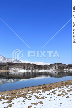 Lake Aoki and Shirouma Mountains waiting for spring Lake Aoki and Shirouma Mountains waiting for spring 74943820
