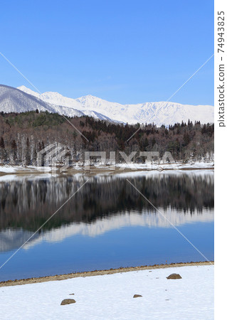Lake Aoki and Shirouma Mountains waiting for spring Lake Aoki and Shirouma Mountains waiting for spring 74943825