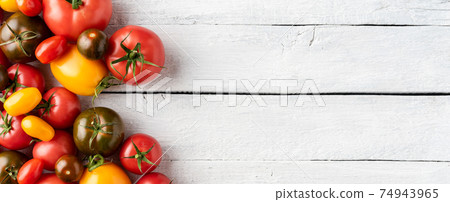 Red, yellow and green tomatoes on white wooden background with copyspace. Top view. Banner Red, yellow and green tomatoes on white wooden background with copyspace. Top view. Banner 74943965
