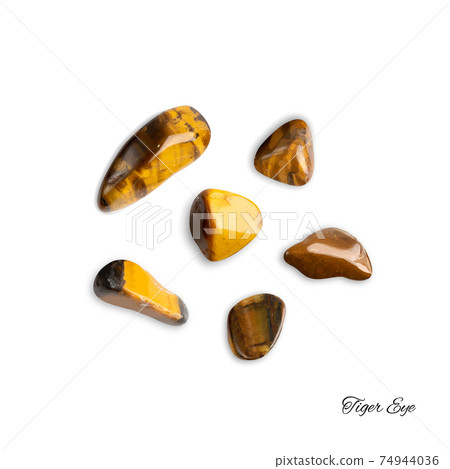 Tiger eye pebbles isolated, brown polished quartz stones Tiger eye pebbles isolated, brown polished quartz stones 74944036