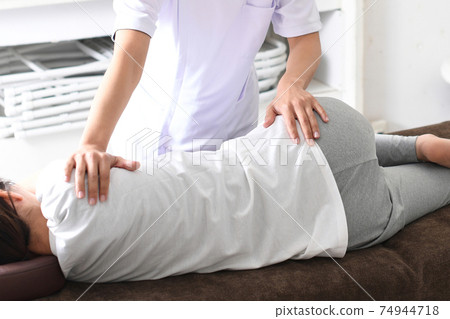一名女子在整脊骨盆矯正期間接受按摩 74944718