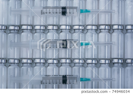Medicine, Injection, vaccine and disposable syringe, drug concept. Sterile vial medical syringe needle. Glass medical ampoule vial for injection. Medicine, Injection, vaccine and disposable syringe, drug concept. Sterile vial medical syringe needle. Glass medical ampoule vial for injection. 74946034