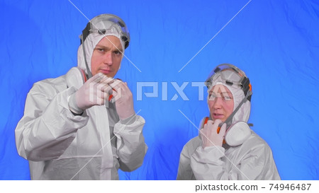 Doctor health worker in respirator. Slow motion. People portrait, wearing protect medical antibacterial antiviral aerosol spray paint mask. 74946487