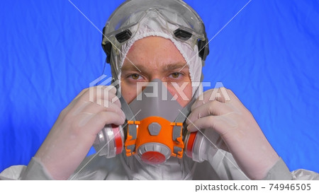 Scientist virologist in respirator. Man close up look, wearing protective medical mask. Concept health safety N1H1 coronavirus epidemic 2019 nCoV. 74946505