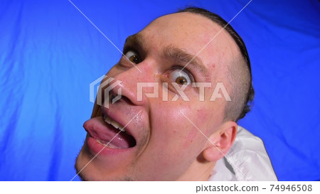 Crazy scientific virologist in respirator. Slow motion. Man close up look, wearing protective medical mask. Covid-19. Chroma key blue film. 74946508