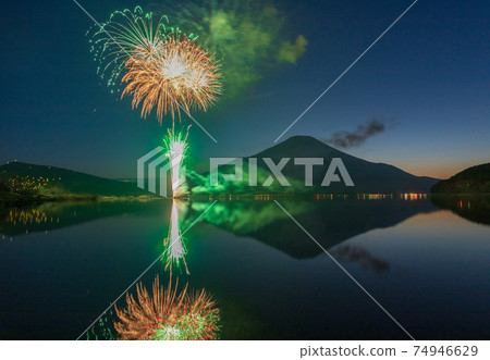Mt. Fuji and fireworks reflected in Lake Yamanaka in winter 74946629
