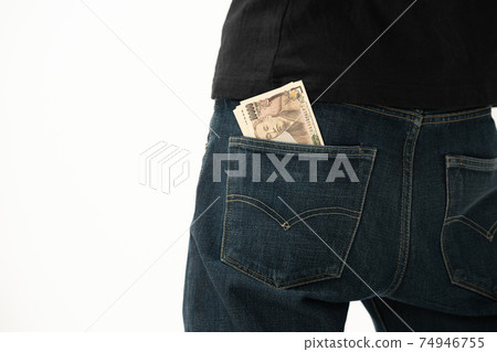A man who puts money in his pocket, back view A man who puts money in his pocket, back view 74946755