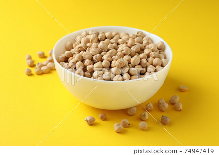 Bowl with fresh chickpea on yellow background 74947419