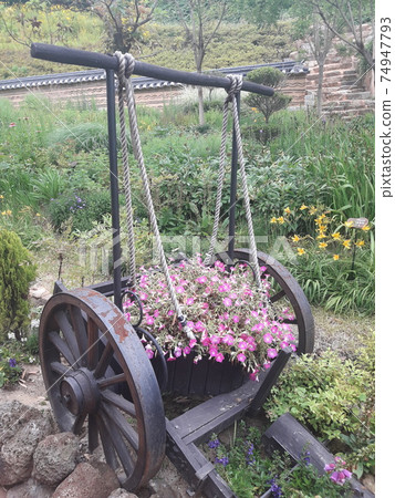 Old spring wagon with flowers 74947793