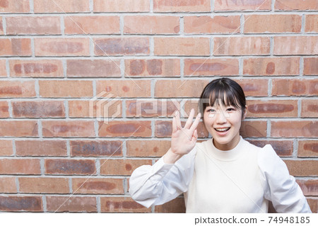 A woman giving a Vulcan greeting A woman giving a Vulcan greeting 74948185