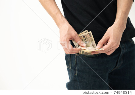 A man counting money in his pocket A man counting money in his pocket 74948514