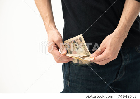 A man counting money in his pocket A man counting money in his pocket 74948515