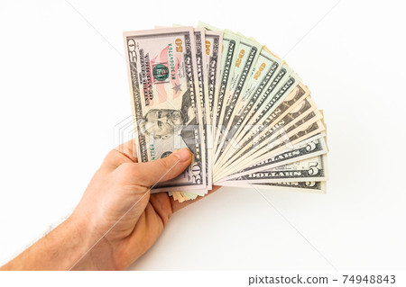 Hand with money isolated on a white background. US dollar bills Hand with money isolated on a white background. US dollar bills 74948843