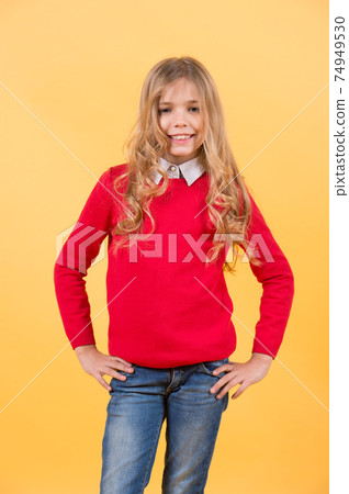 Kid in red sweater, jeans with long hair happy smile Kid in red sweater, jeans with long hair happy smile 74949530