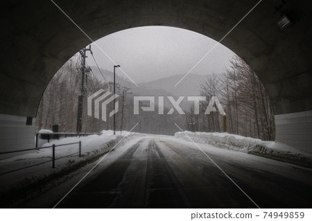 Snowy road surface outside the tunnel Snowy road surface outside the tunnel 74949859