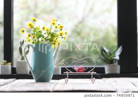 Teal tea pot with yellow Chrysanthemum inside and pink miniature heart chair Teal tea pot with yellow Chrysanthemum inside and pink miniature heart chair 74950971