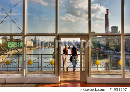 Two young people look at the city  74951397
