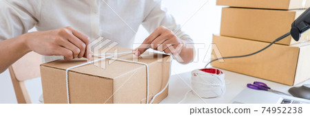 Shipment Online Sales, Small business or SME entrepreneur owner delivery service and working packing box, business owner working checking order to confirm before sending customer in post office 74952238