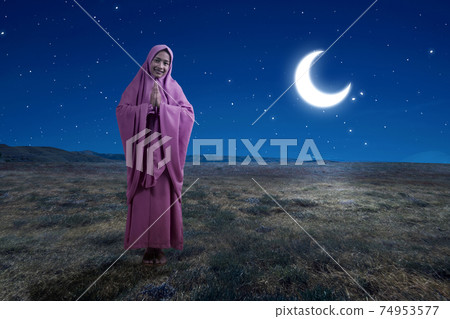 Asian Muslim woman in veil with greeting gesture 74953577