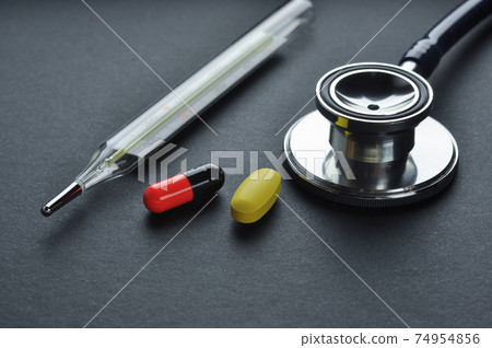 Stethoscope, Thermometer and Pills. Stethoscope, Thermometer and Pills. 74954856