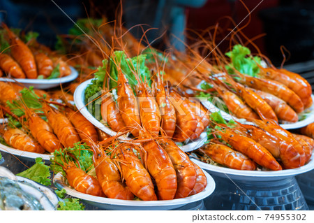 Plates of huge boiled shrimp at the street food market Plates of huge boiled shrimp at the street food market 74955302