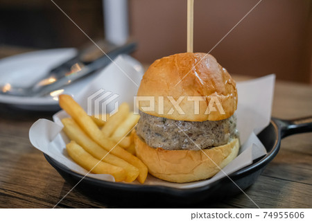 Close up of Truffle Burger with French Fries served on pan Close up of Truffle Burger with French Fries served on pan 74955606