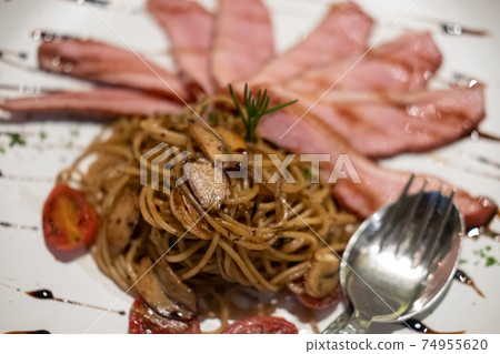 Smoked duck spaghetti served on plate. Smoked duck spaghetti served on plate. 74955620
