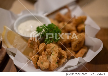 Close up of Fried Squid served on plate. Close up of Fried Squid served on plate. 74955621