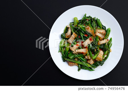 Stir fried chinese kale with crispy pork belly Stir fried chinese kale with crispy pork belly 74956476