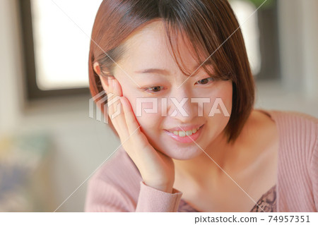 A smiling woman with a cheek stick A smiling woman with a cheek stick 74957351