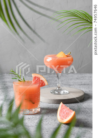 Two rosemary grapefruit sodas on grey. 74957646