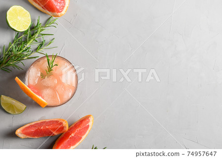 Grapefruit sparkling cocktails or lemonade garnish rosemary. View from above. Close up. 74957647